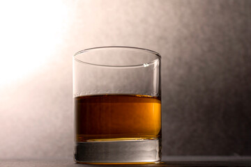glass goblet with whiskey on a dark background