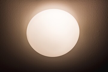 The light on the wall. Circular light. Light and heat source. Energy saving.