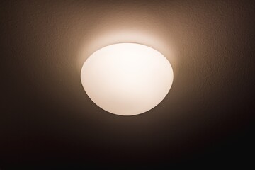 The light on the wall. Circular light. Light and heat source. Energy saving.