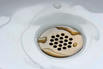 Water dripping into sink drain holes