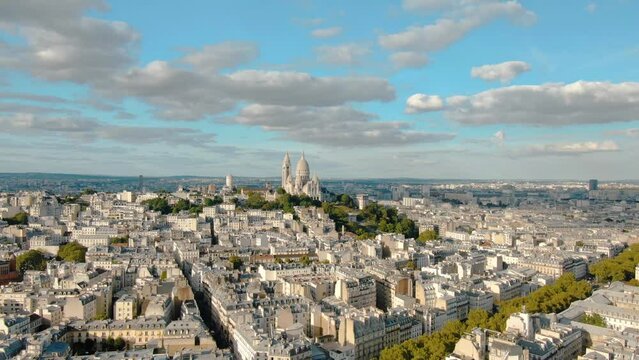 Establishing aerial view of Paris Sacre-Coeur and Montmartre hill on a beautiful day, Paris France gothic architecture 