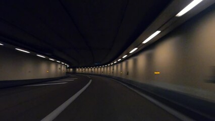 Point of view car driving in an empty tunnel - Powered by Adobe