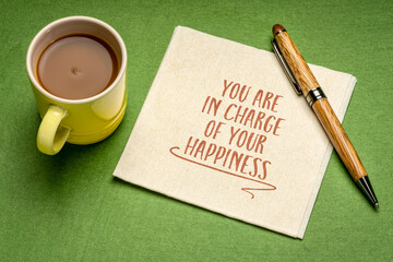 You are in charge of your happiness - inspirational reminder note on a napkin with a cup of coffee, positive mindset and personal development concept