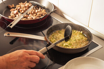 Prepared from a sauté onion, tomato and pepper for a paella, in the kitchen of a house.