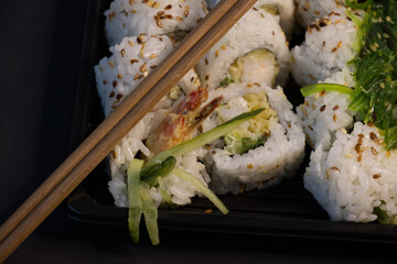 Sushi rolls with chopsticks