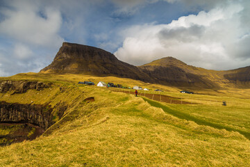 Tourists on the walking path on Vagar island, Gasadalur, Faroe Islands.