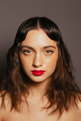 Portraits of a beautiful girl with makeup and red lips