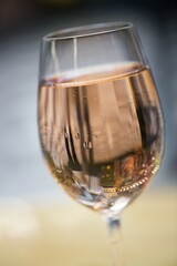 detail of glass with wine, glass and dew drops, white wine in gold, celebration of the new year, toast of celebrations and events