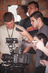 Behind scenes. Film crew team shooting movie scene. Group filmmaking