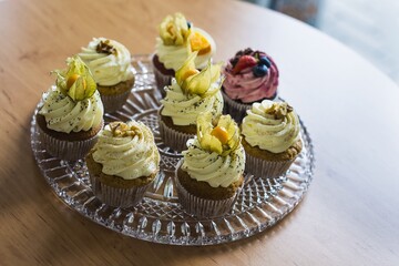 Close-up of Muffin in a basket on a glass plate placed on a table.