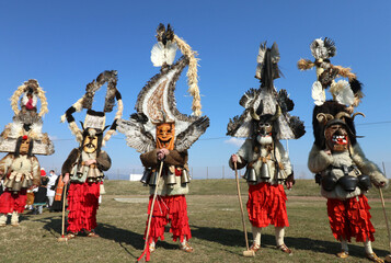 Fototapeta na wymiar Masquerade festival in Elin Pelin, Bulgaria. People with mask called Kukeri dance and perform to scare the evil spirits. 