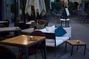 tables and armchairs of an outdoor restaurant
