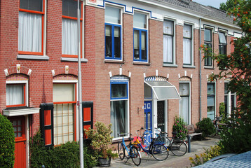 beautiful houses with windows, entrance, bicycles at the entrance in summer