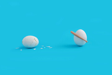 Funny Easter concept with white eggs fighting with baseball bat