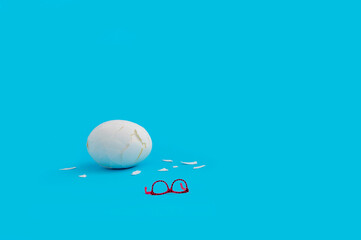 Broken egg with eyeglasses as creative minimal Easter concept