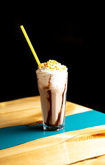 milkshake with chocolate on a table in a cafe at sunset