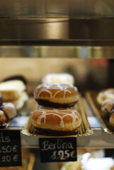 Fototapeta na wymiar berlina de crema y chocolate en mostrador de pastelería