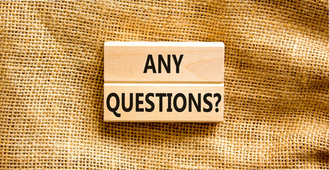 Any questions symbol. Concept words Any questions on wooden blocks on a beautiful canvas table canvas background. Business and Any questions Q and A concept, copy space.