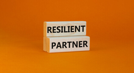 Resilient partner symbol. Concept words Resilient partner on wooden blocks on a beautiful orange table orange background. Business resilience and resilient partner concept, copy space.