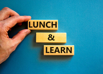 Lunch and learn symbol. Concept words Lunch and learn on wooden blocks. Beautiful blue table blue...