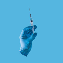 a hand in a blue medical glove with a syringe on a blue background