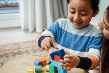 Asian mother and son kid having fun playing games with wood toy blocks at home - Family time...
