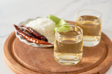 Mexican tequila splash by lime falling into the glass.