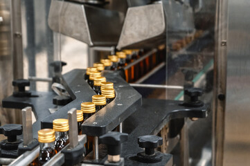 Production line with numerous closed bottles of cognac
