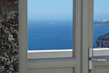 A typical door in Santorini with a breathtaking view of the Aegean Sea and the blue sky