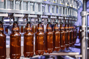 Filling plastic bottles with various drinks on an automatic filling machine