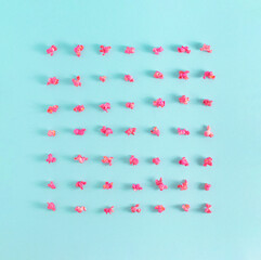 Pink popcorn on Blue Pastel Background. Minimal Cinema and Entertainment concept. Modern geometric composition.