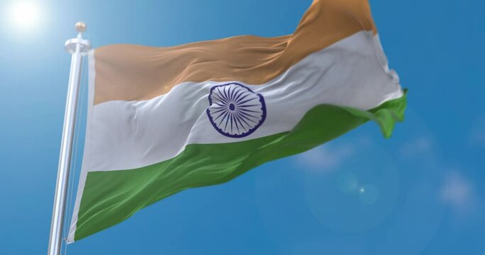 View of Indian flag flapping on flagpole with sky behind