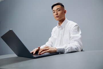 businessmen working on a laptop sitting at a table in the office Lifestyle