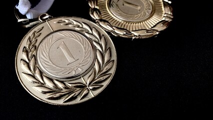 Gold, silver, bronze medals and cups on a black background. A large number of significant awards for performances in front of people and high-level sporting achievements