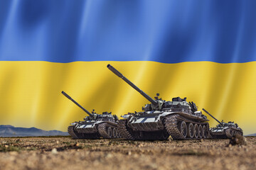 Tanks lined up in front of a Ukrainian flag. Several military army war battle tank vehicles on the...