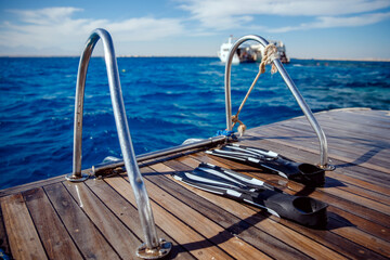 Diving with scuba gear and flippers in sea, snorkeling tour on boat yacht. Bright photo with sun extreme rest © Parilov