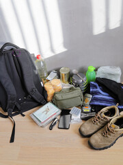 Survival set, backpack and necessary items in emergency and evacuation, vertical format with copy...