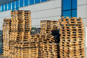 Stacked wooden pallets at a storage or near a shop