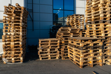 Stacked wooden pallets at a storage or near a shop