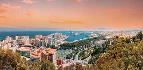Malaga, Spain. Panorama Cityscape Elevated View Of Malaga In Sunny Summer Evening. Altered Sunset...