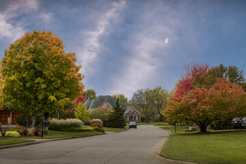 View of Midwestern neighborhood early in the evening in autumn; rising moon above