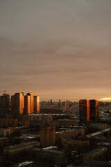 Evening panorama of Moscow, setting sun is reflected in office buildings. Construction of new houses