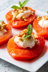 Traditional Turkish style quince dessert. The quince is cooked until soft, sherbet is poured on it, and served with cream and walnuts. It is one of the most popular Turkish desserts.(Ayva Tatlisi)