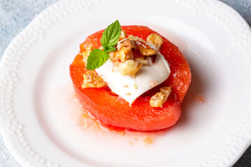 Traditional Turkish style quince dessert. The quince is cooked until soft, sherbet is poured on it, and served with cream and walnuts. It is one of the most popular Turkish desserts.(Ayva Tatlisi)