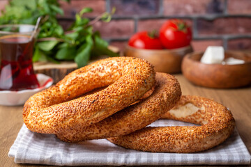 Turkish fast food bagel called Simit. Turkish bagel Simit with sesame. Bagel is traditional Turkish bakery food. Turkish name; simit - gevrek - obrazy, fototapety, plakaty