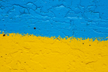concrete wall painted in yellow and blue like Ukrainian flag, the country of victim of the aggressor