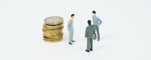 On the white surface of the coin, figures of businessmen stand nearby - they are talking.