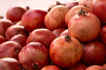 Red ripe pomegranates on the counter in the store. Healthy food.