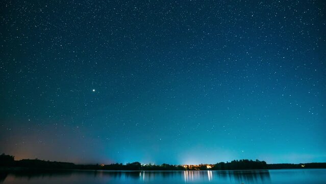 Lyepyel District, Vitebsk Province, Belarus. Real Colorful Night Stars Above Lepel Lake. Natural Starry Sky Background Backdrop Landscape. Time lapse. 4K.