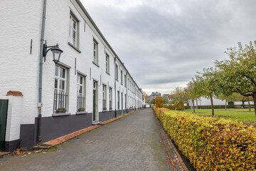Hoogstraten, Belgium, 11 november 2021, UNESCO listed Beguinage of Hoogstraten, Belgium. The beautiful medieval Beguinage of Hoogstraten, showing the row of white houses under a clouded sky. High